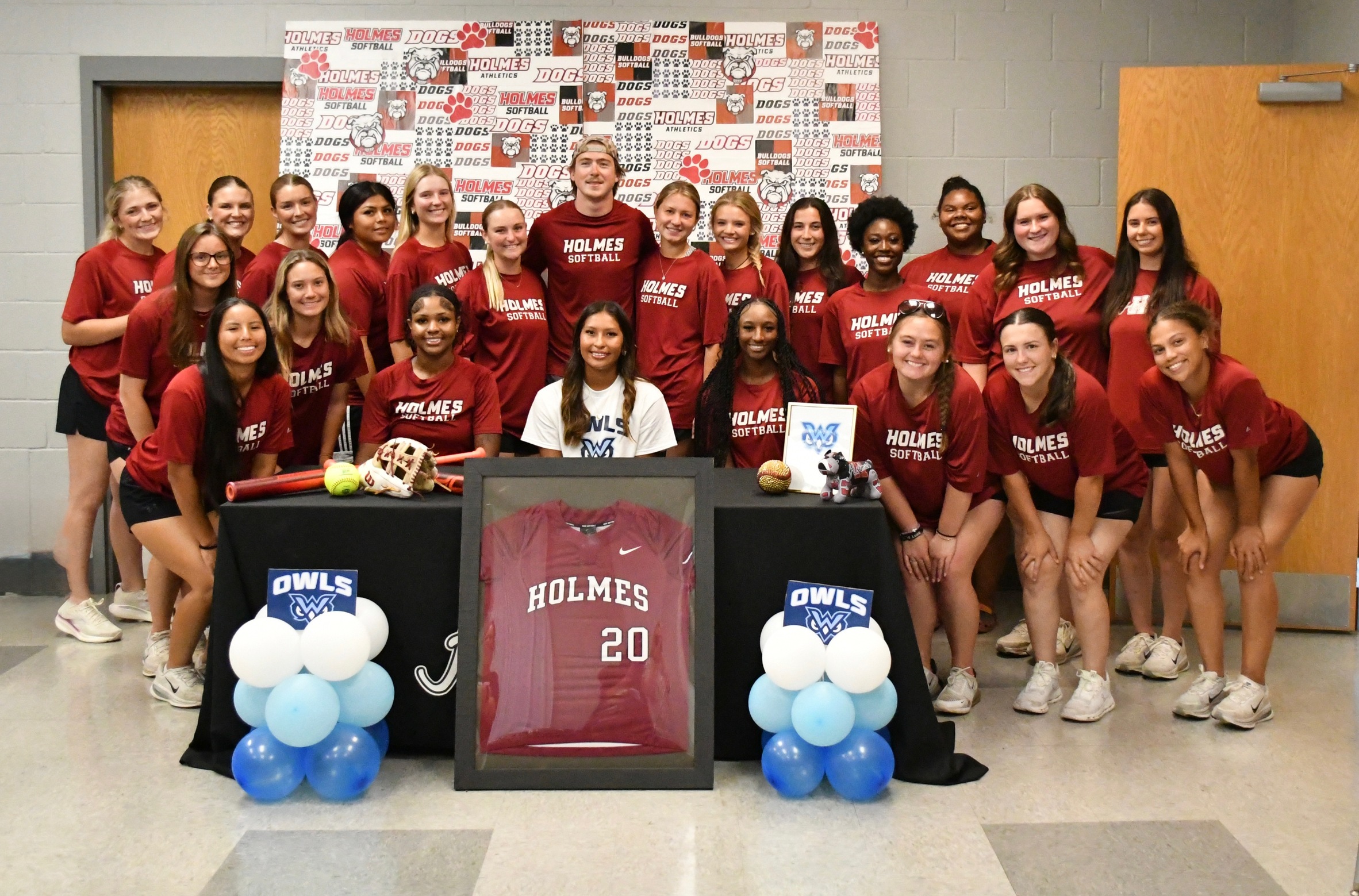 Miley Billie is surrounded by her teammates during a signing ceremony Monday afternoon in the softball field house on the Goodman Campus.